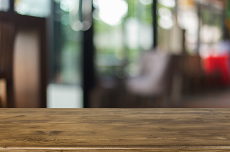 Selected focus empty brown wooden table and Coffee shop blur background with bokeh image, for product display montageの写真素材