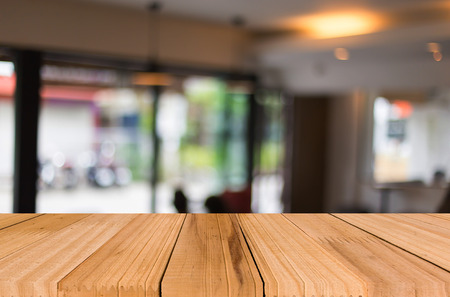 Selected focus empty brown wooden table and Coffee shop blur background with bokeh image, for product display montageの写真素材