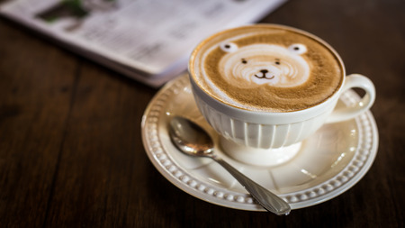 Hot latte art coffee cup on table, vintage and retro style.の写真素材