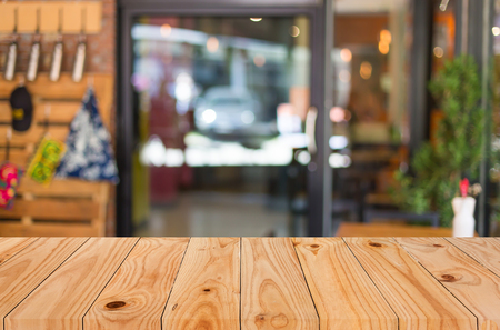 Selected focus empty brown wooden table and Coffee shop blur background with bokeh image, for product display montage.の写真素材