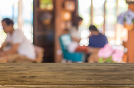 Selected focus empty brown wooden table and Coffee shop blur background with bokeh image, for...