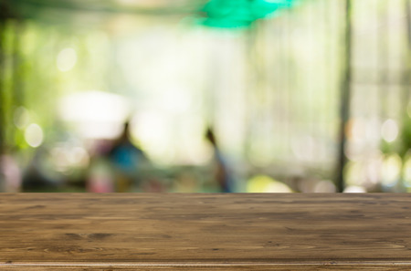 Selected focus empty brown wooden table and Coffee shop blur background with bokeh image, for product display montage.の写真素材