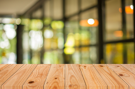 Selected focus empty brown wooden table and Coffee shop blur background with bokeh image, for product display montage.の写真素材