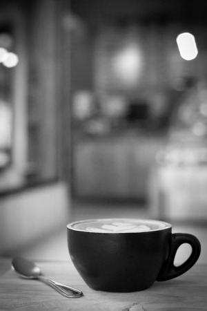 Hot latte art coffee cup on table, vintage and retro style black and white tone.の写真素材