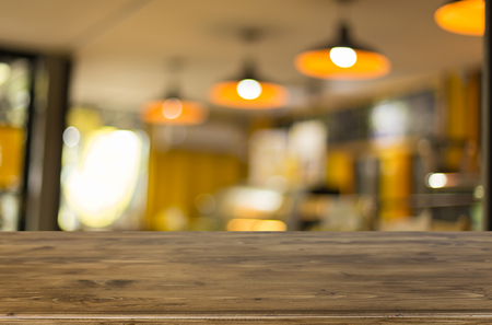 Selected focus empty brown wooden table and Coffee shop blur background with bokeh image, for product display montage.の写真素材