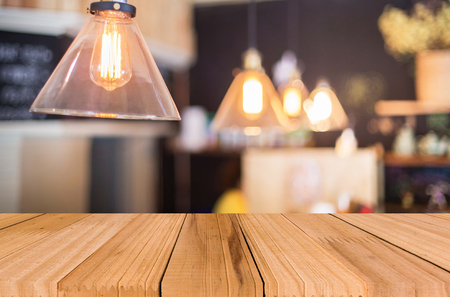 Selected focus empty brown wooden table and Coffee shop blur background with bokeh image, for product display montage.の写真素材