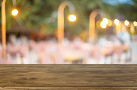 Selected focus empty brown wooden table and Coffee shop blur background with bokeh image.の写真素材