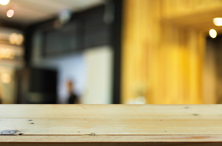 Selected focus empty brown wooden table and Coffee shop blur background with bokeh image, for product display montage.の写真素材