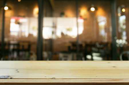 Selected focus empty brown wooden table and Coffee shop blur background with bokeh image.の写真素材
