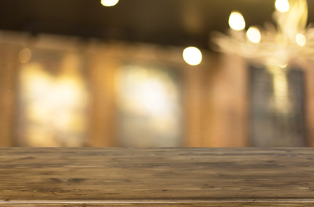 Selected focus empty brown wooden table and Coffee shop blur background with bokeh imageの写真素材