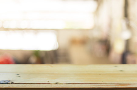 Selected focus empty brown wooden table and Coffee shop blur background with bokeh image, for...