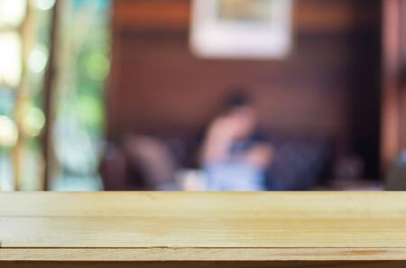 Selected focus empty brown wooden table and Coffee shop blur background with bokeh image. for your photomontage or product displayの写真素材