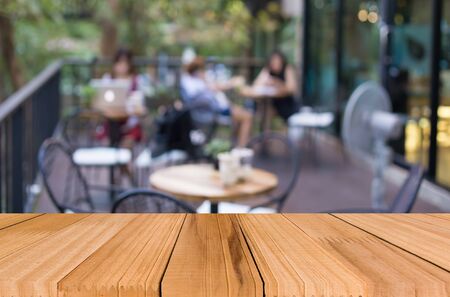 Selected focus empty brown wooden table and Coffee shop blur background with bokeh image, for product display montageの写真素材