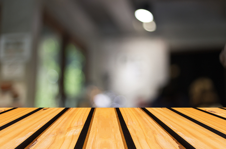 Selected focus empty brown wooden table and Coffee shop blur background with bokeh image, for product display montageの写真素材