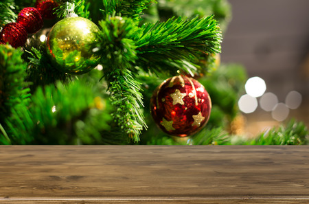 Christmas holiday background with empty wooden deck table over festive bokeh. Ready for product montageの写真素材