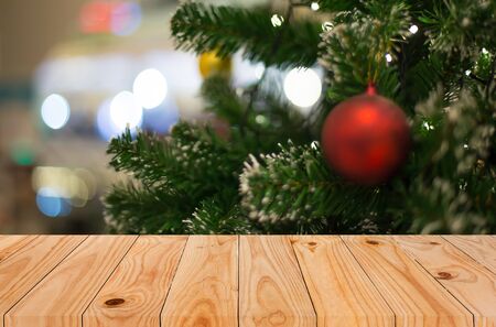 Christmas holiday background with empty wooden deck table over festive bokeh. Ready for product montageの写真素材