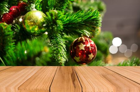 Christmas holiday background with empty wooden deck table over festive bokeh. Ready for product montageの写真素材