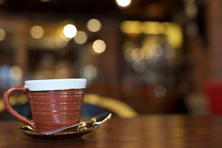 Hot art Latte Coffee in a cup on wooden tableの写真素材