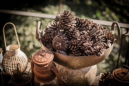 Pine Cone in basket on old wood background.の写真素材