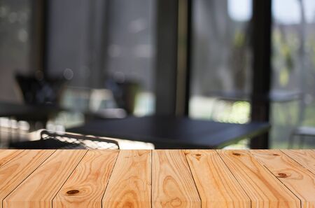 Selected focus empty brown wooden table and Coffee shop blur background with bokeh image. for your photomontage or product display.の写真素材