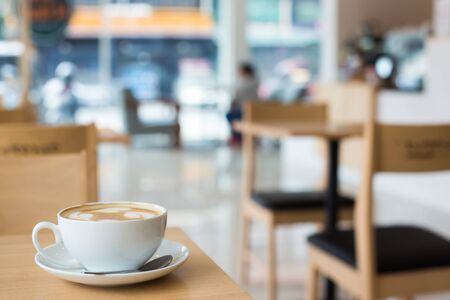 Hot art Latte Coffee in a cup on wooden table.の写真素材
