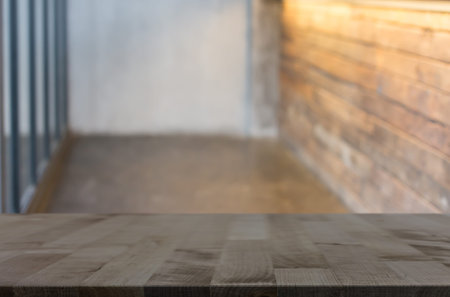 Selected focus empty brown wooden table and Coffee shop blur background with bokeh image. for your...