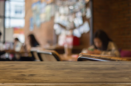 Selected focus empty brown wooden table and Coffee shop blur background with bokeh image. for your...
