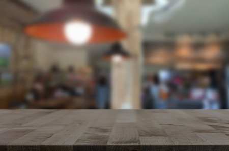 Selected focus empty brown wooden table and Coffee shop blur background with bokeh image, for product display montage.の写真素材
