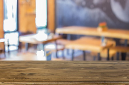 Selected focus empty brown wooden table and Coffee shop blur background with bokeh image