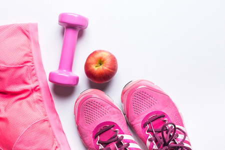Women's sports bra,foot ware, Dumbbell and apple. Fitness wear and equipment. Sport fashion, Sport accessories, Sport equipment. for healthy conceptの写真素材