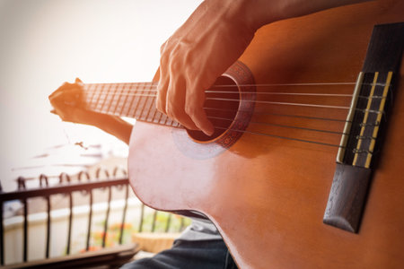 boys hand with a guitar.