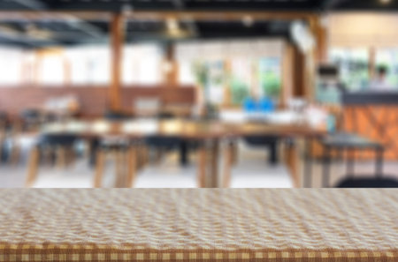 Selected focus empty brown wooden table and Coffee shop blur background with bokeh image. for your...