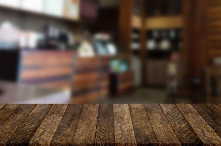 Selected focus empty brown wooden table and space of Coffee shop restaurant blur background with bokeh image, for product display montage.の写真素材