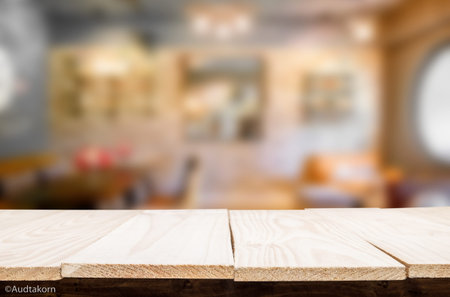 Selected focus empty brown wooden table and Coffee shop blur background with bokeh image, for...