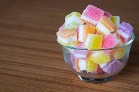 variety of gelly and candies on a wooden background.の写真素材