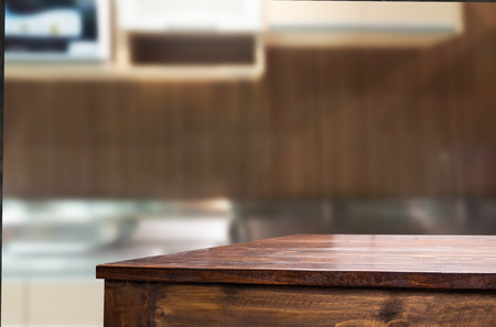 Dining table on blurred brown kitchen interior background.の写真素材