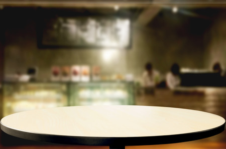 Selected focus empty brown wooden table and Coffee shop blur background with bokeh image, for product display montageの写真素材