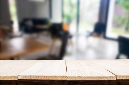 Selected focus empty brown wooden table and Coffee shop blur background with bokeh image, for product display montage.の写真素材