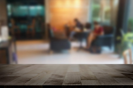 Selected focus empty brown wooden table and Coffee shop blur background with bokeh image. for your...
