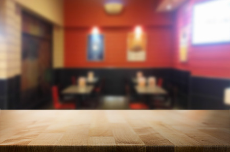 Selected focus empty brown wooden table and Coffee shop or restuarant blur background with bokeh image. for your photomontage or product display.の写真素材