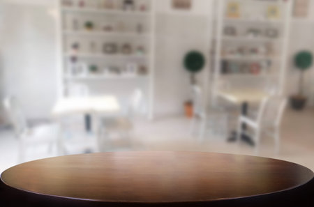 Selected focus empty brown wooden table and Coffee shop blur background with bokeh image. for your...