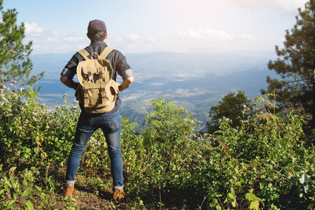 Young Man Traveler with backpack relaxing outdoor with rocky mountains on background Summer vacations and Lifestyle hiking concept.の写真素材