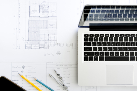 Construction equipment. Repair work. Drawings for building Architectural project, blueprint rolls and divider compass on table. Engineering tools concept. Copy space.の写真素材