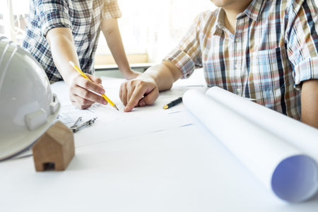 Team of architects people in group on construciton site check documents and business workflow.
