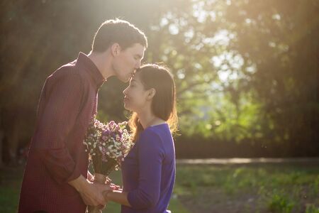 a romantic couple holding Valentines gift and flowers, vintage tone.の写真素材