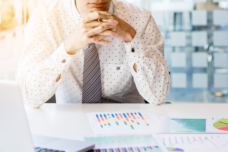 Working process startup. Businessman working at the wood table with new finance project. Modern notebook on table. Pen holding handの写真素材