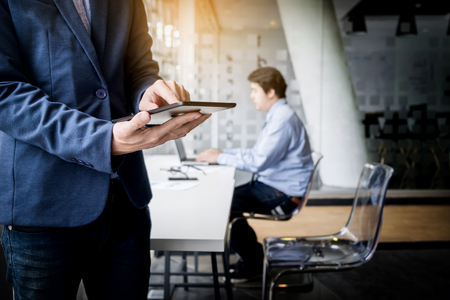Businessman working with tablet in office, closeup.の写真素材
