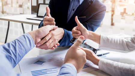 Business handshake of two men demonstrating their agreement to sign agreement or contract between their firms, companies, enterprisesの写真素材