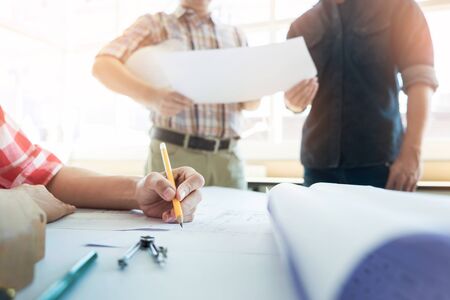 Team of architects people in group on construciton site check documents and business workflow.の写真素材