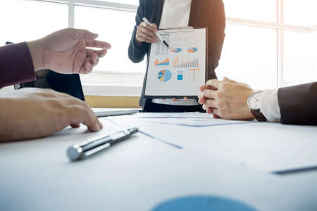 Team work process. young business managers crew working with new startup project. labtop on wood table, typing keyboard, texting message, analyze graph plans and presentation.の写真素材